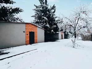 A snow-covered residential area with a building marked with the number 15.