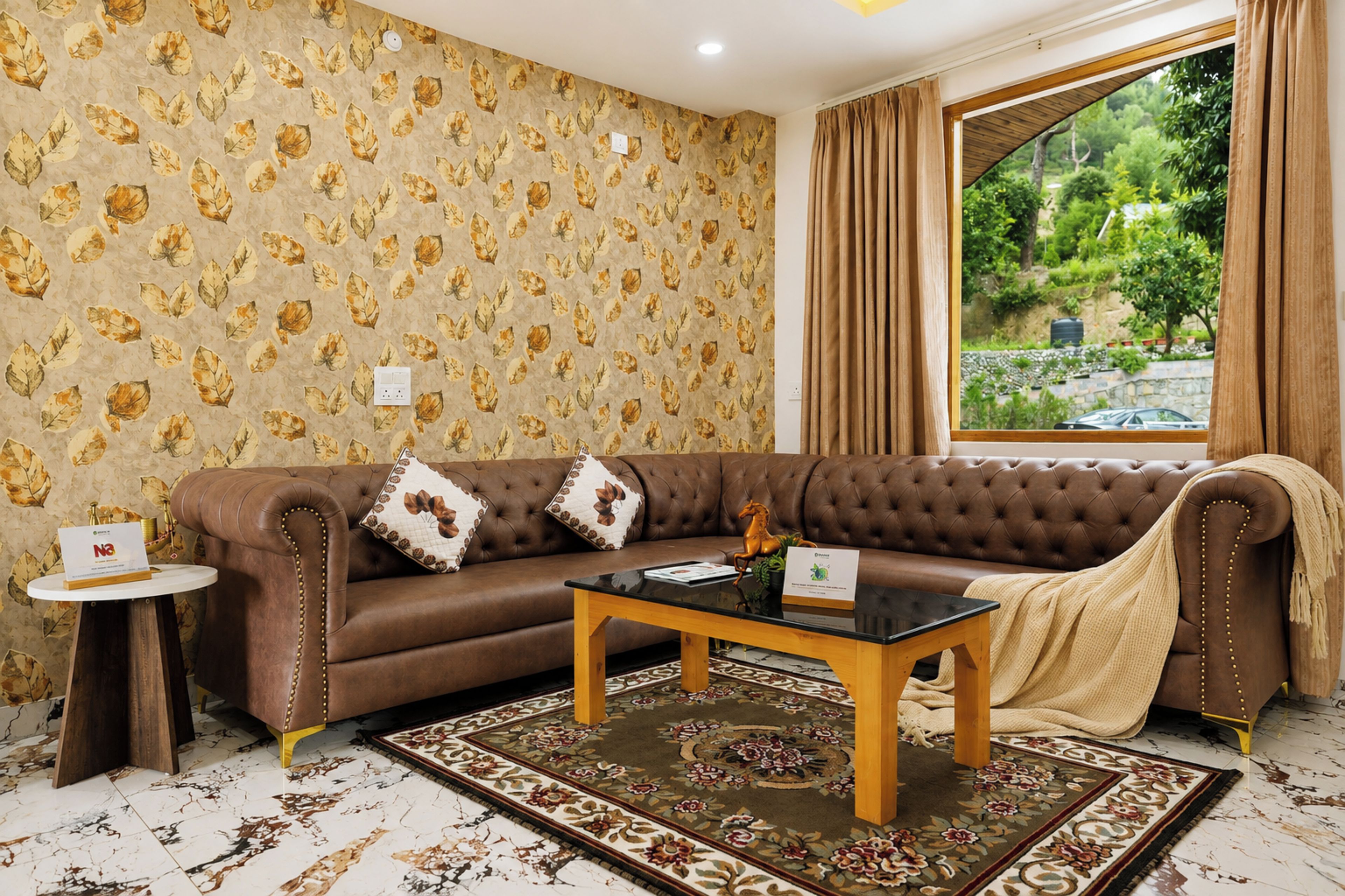 A room with a brown leather sofa, a glass coffee table, a patterned rug, and a window with curtains.