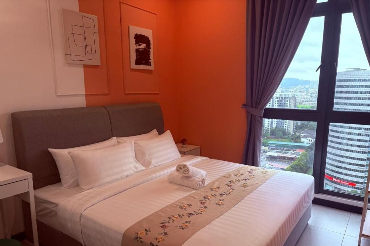 Ein Hotelzimmer mit einem Bett, einem Nachttisch, einem Fenster mit Vorhängen und einem Bild an der Wand.