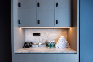 A hotel room with a minibar, a telephone, and toiletries. - Atour Hotel  Shenbei Wanda Plaza (Shenyang)