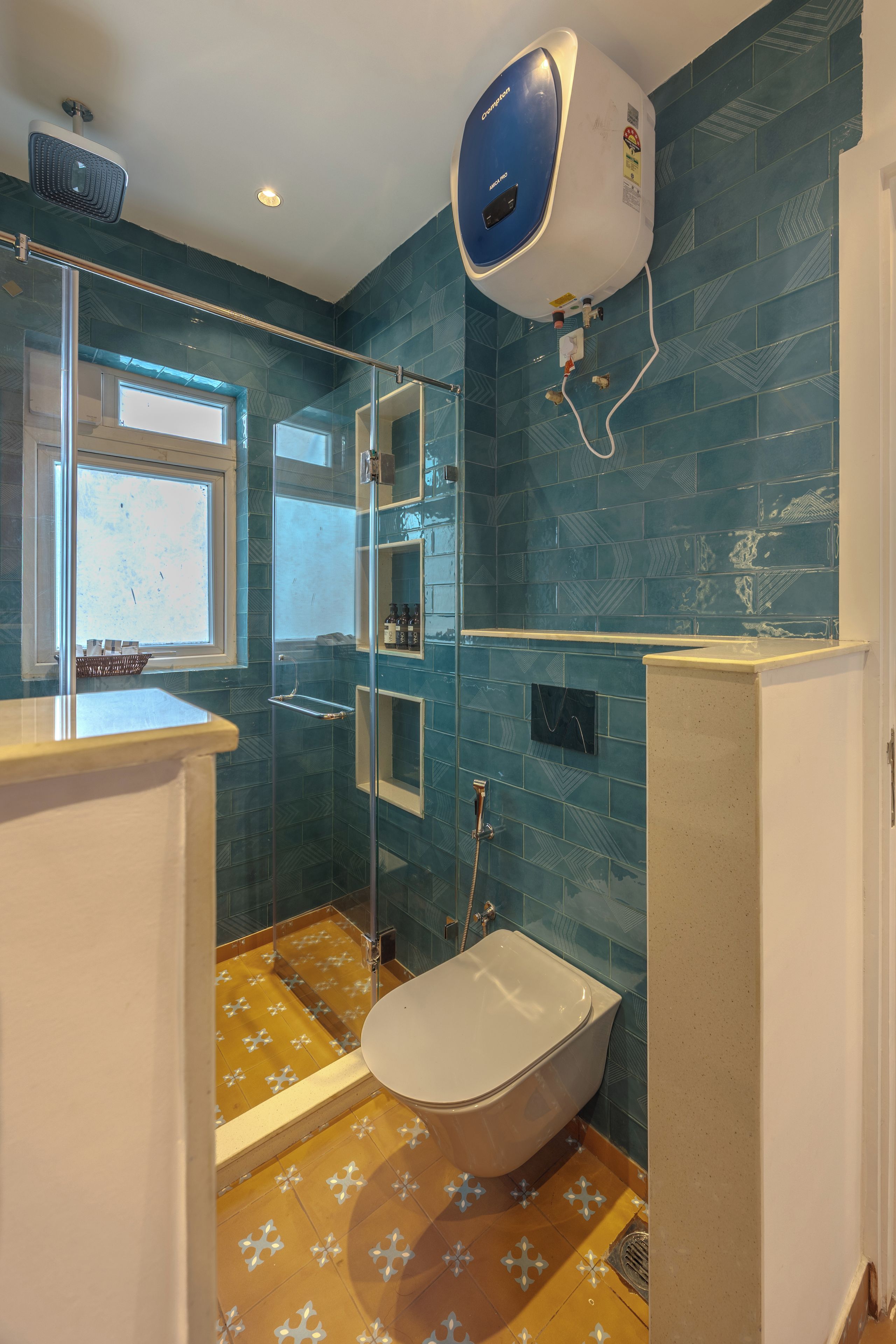 A bathroom with a bathtub, a glass shower enclosure, and a window.