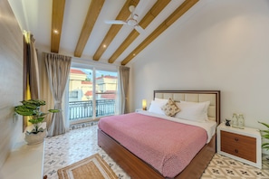 A bedroom with a bed, bedside table, nightstand, curtains, a potted plant, and a view of the outside. - ELIVAAS Signature Mistwood 4-BHK (Parra)