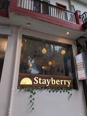 A storefront with a large window displaying the name 'Stayberry.' - Stay Berry (Rishikesh)
