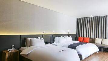 A hotel room with two beds, a bedside table, a nightstand, and a large window with curtains.