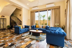 A spacious living room with a large sectional sofa, a coffee table, and a patterned rug.