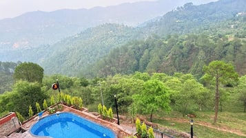 A swimming pool with a view of a mountainous landscape.
