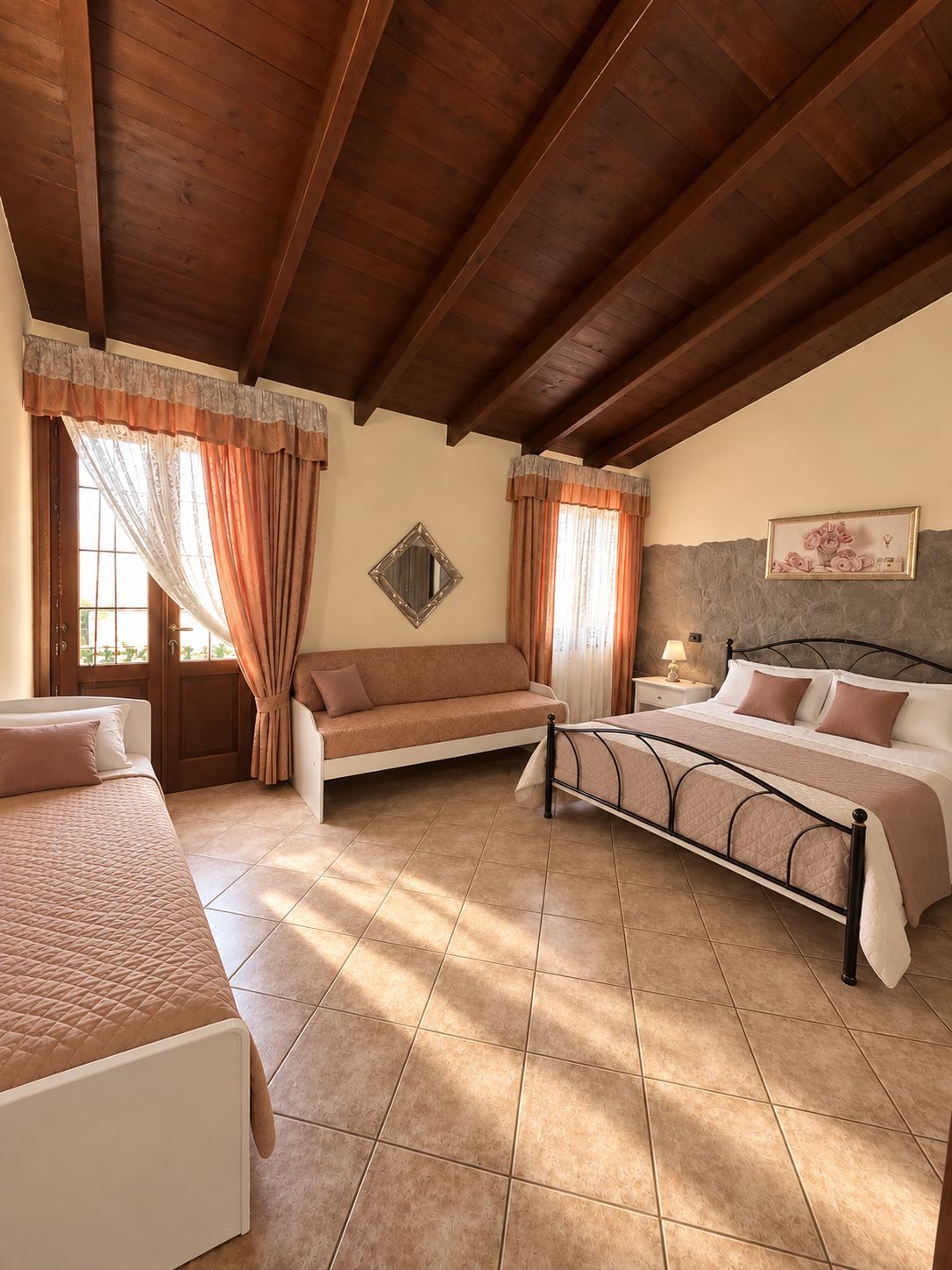 A bedroom with a bed, a sofa, and a nightstand.