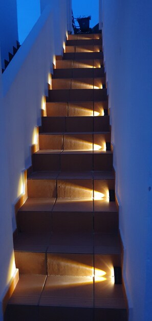 A staircase with illuminated handrails and steps. - Cielo Dorado – Luxury Ibiza-Style Apartment with Sunny Rooftop (Alhama de Murcia)