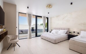 A modern hotel room with a bed, a chair, a desk, and a large window. - Cozy home in Kastel Stari with private swimming pool, can be inside or outside (Kastel Stari)