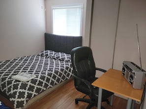 A bedroom with a bed, a chair, a table, and a radio. - Entire house or single room open to all offers (Ottawa)