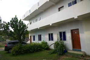 A two-story building with a flat roof, multiple windows, and a front door. - REHO RESORT (Rameshwaram)