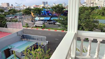 A cityscape with a view of a road, buildings, and a billboard.