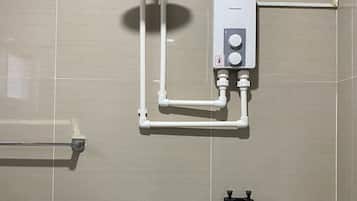 A bathroom with a shower, a toilet, and a towel rack.