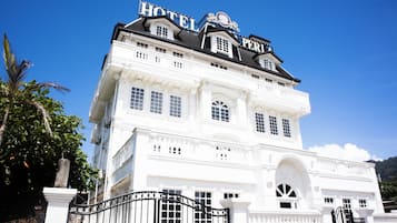 A large, white building with a prominent sign reading 'HOTEL PARI' at the top.