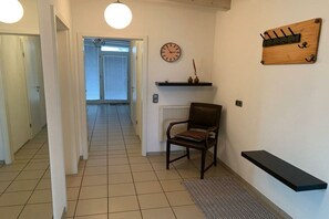 A hallway with a chair, a clock, and a coat rack. - Kalkofen, Konstanz district, Lake Constance (Kalkofen)