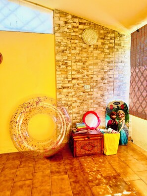 A room with a brick wall, a yellow door, and a tiled floor. - Cozy home just a 5-minute walk from the beach, along Geremeas Bay (Geremeas)