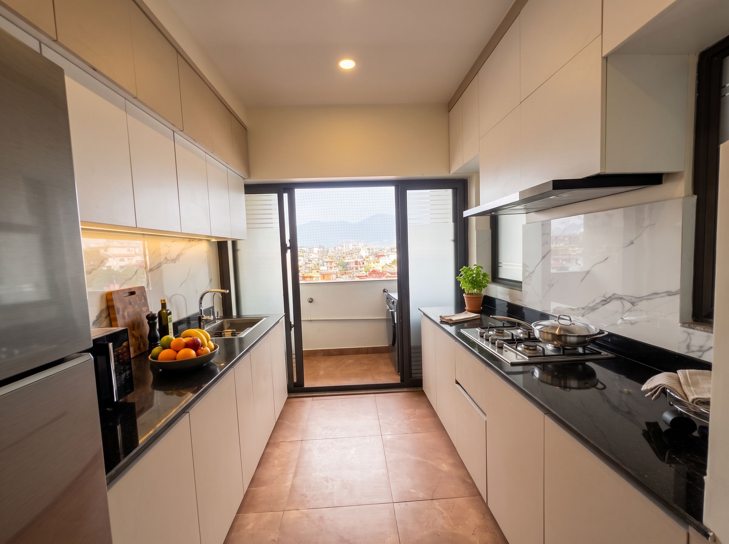 A modern kitchen with a view of a cityscape through a sliding door.
