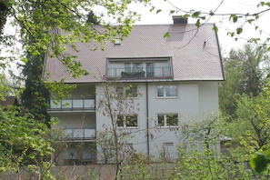 A two-story residential building with a tiled roof, balconies, and windows. - Holiday apartment with 2 bedrooms (Freiburg)