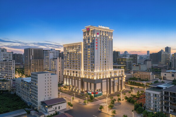 A high-rise hotel with multiple floors, a prominent entrance, and a surrounding urban environment.