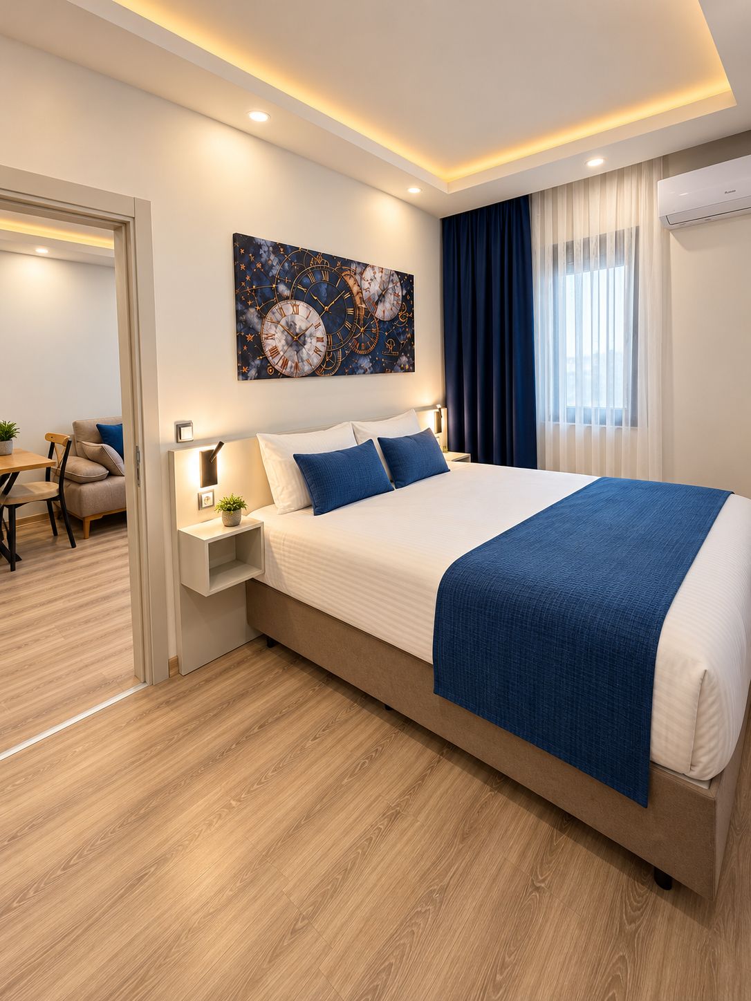 A modern hotel room with a large bed, a bedside table, a wall clock, and a window with curtains.