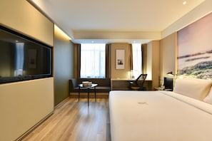 A hotel room with a bed, a desk, a chair, a TV, and a window with curtains. - Atour Hotel  Lvshunkou centralsquare (Dalian)