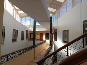 A multi-level interior with a staircase, railings, and a skylight. - SIERRA RONDA CENTER—HYDROMASSAGE (Ronda)