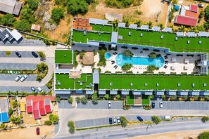 An aerial view of a hotel with multiple buildings, a swimming pool, and a parking area. - Wariruri 214 by Bocobay • Luxury Resort Stay (Noord)