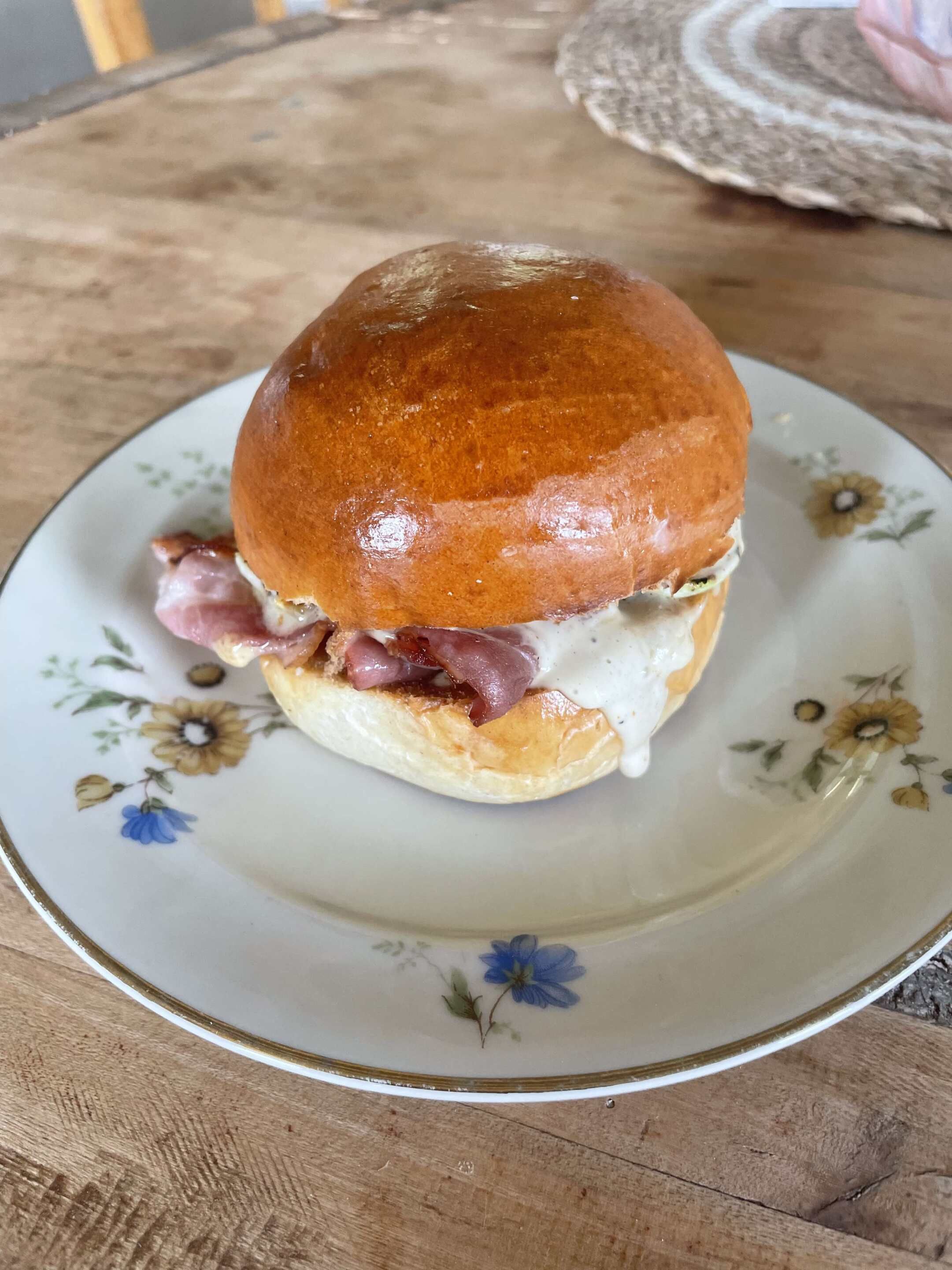 A sandwich on a floral plate.