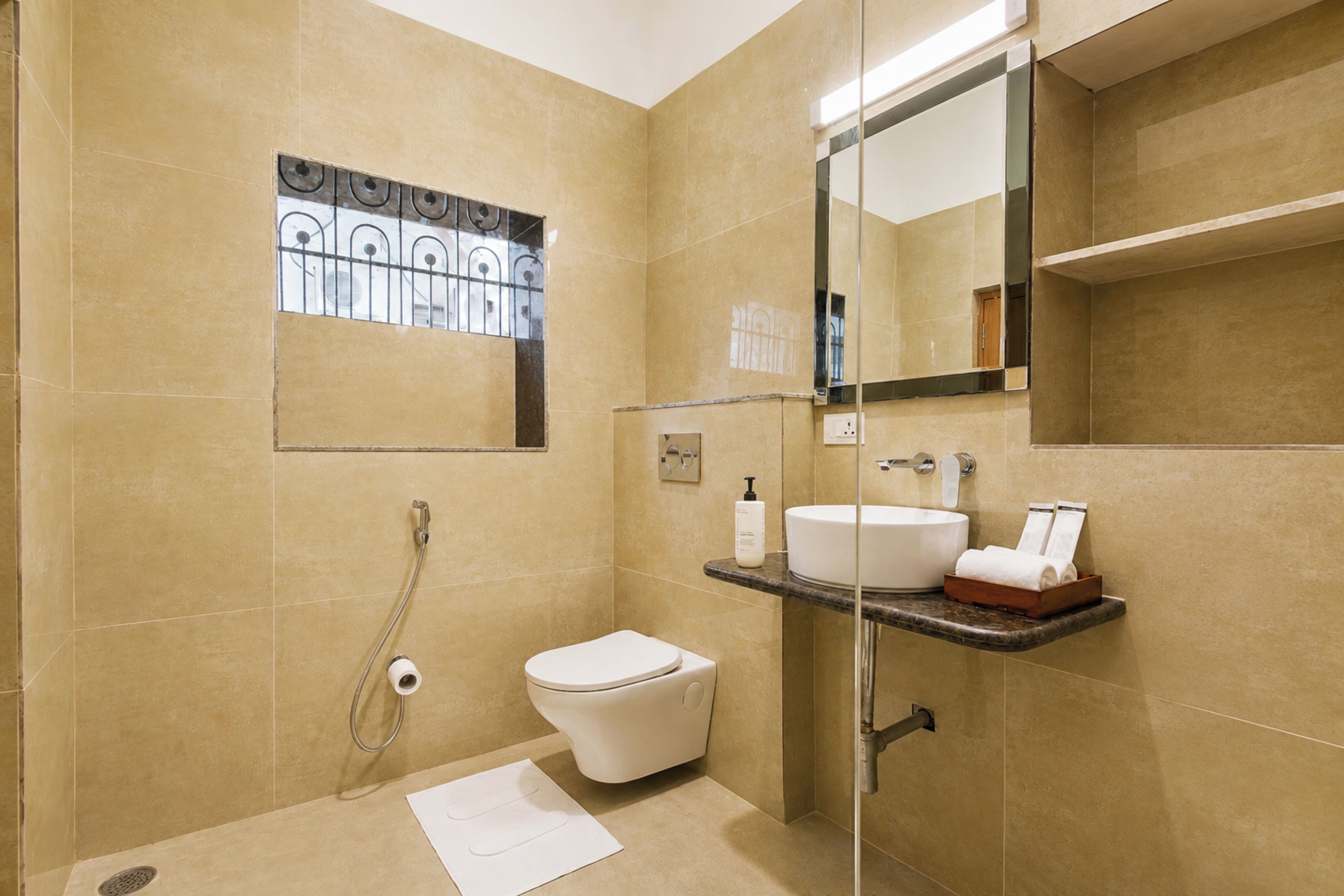 A modern bathroom with a toilet, sink, and shower area.