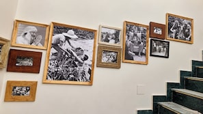 A wall with multiple framed photographs arranged in a gallery format. - Shree Rajneesh Osho Ashram (Rishikesh)