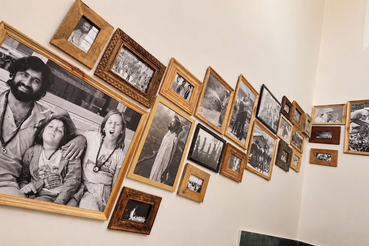 A wall with multiple framed photographs arranged in a row.