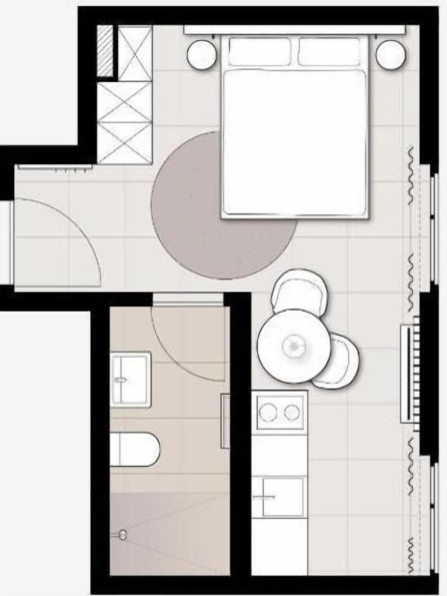 Een plattegrond met een slaapkamer, badkamer, keuken en woonruimte.