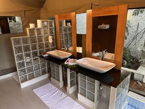 A bathroom with two sinks, a mirror, and a window with a view of foliage. - Sau Bay Resort and Spa (Na Sau Bay)