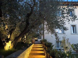 A pathway leading to a building with a stone wall on one side and trees on the other. - Your Private Tuscan Villa 17 Min to Florence · Private Pool · 6 Suites · 7 Baths (Firenze)