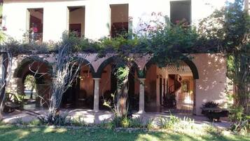 A building with multiple arches and a covered patio area.