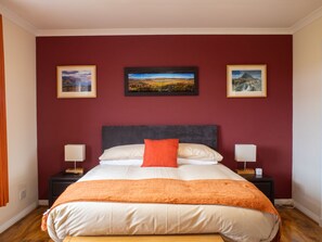 A hotel room with a large bed, two bedside tables with lamps, and three framed pictures on the wall. - Skeabost Bungalow by Interhome (Mid Skye)