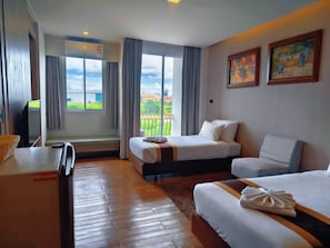 A hotel room with two beds, a desk, a television, and large windows with a view. - Bright Hotel Khon Kaen (Khon Kaen)