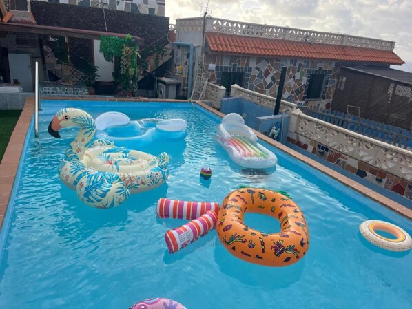 A swimming pool with various inflatable toys and a decorative fence. - Vacation Apartment 'Estudio Kylie' with Sea View, Wi-Fi and Air Conditioning (Santa Cruz de Tenerife)