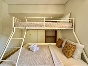A bunk bed room with a ladder, a bed with a quilt, and two pillows. - VILAMOURA GOLF APARTMENT 4 WITH POOL by HOMING (Vilamoura)