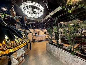 A lobby with a chandelier, marble flooring, and indoor plants. - Matsudo Grand Hotel (Matsudo)