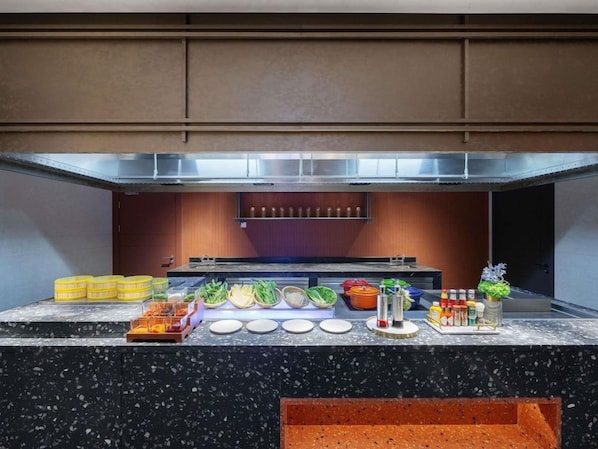 A buffet setup with various food items and condiments. - Novotel Zibo New Hongcheng (Zibo)