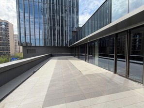 A modern building with a glass facade and a flat roof terrace. - Novotel Zibo New Hongcheng (Zibo)