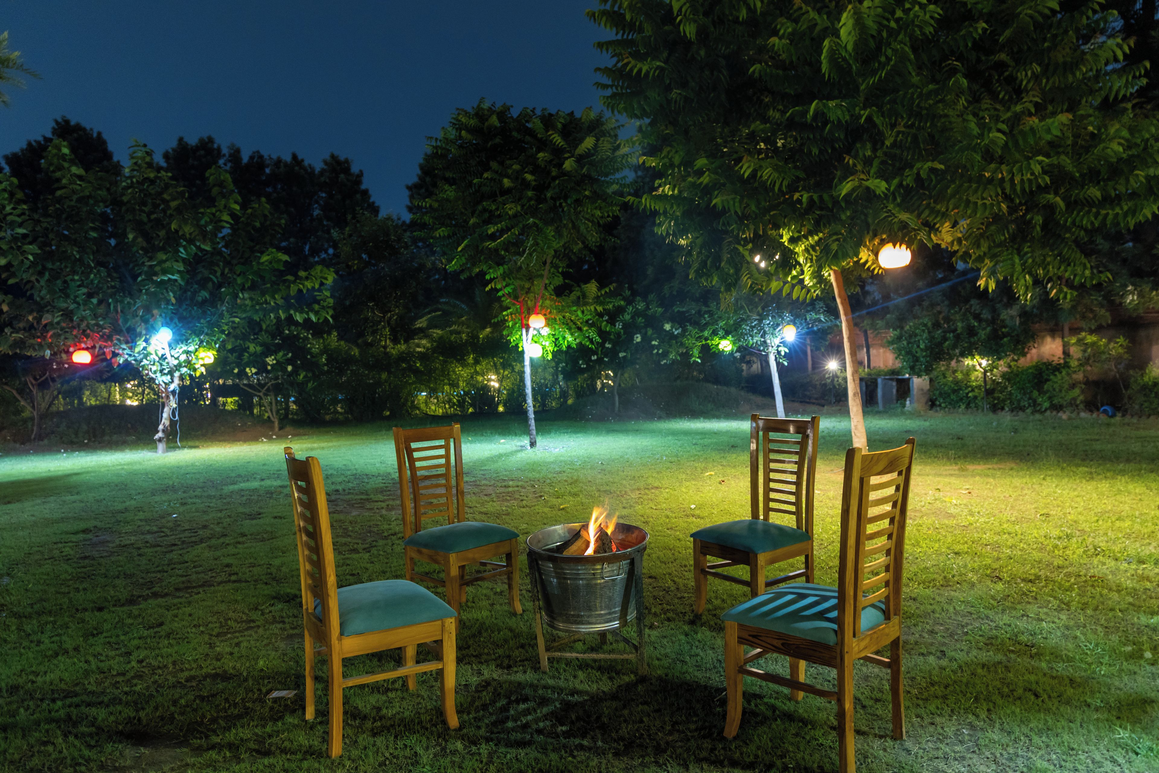 An outdoor seating area with chairs and a fire pit.