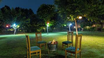 An outdoor seating area with chairs and a fire pit.