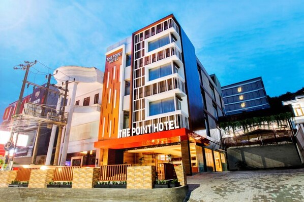 A hotel with a modern facade, multiple floors, and a prominent signage. - The Point Hotel Balikpapan (Balikpapan)