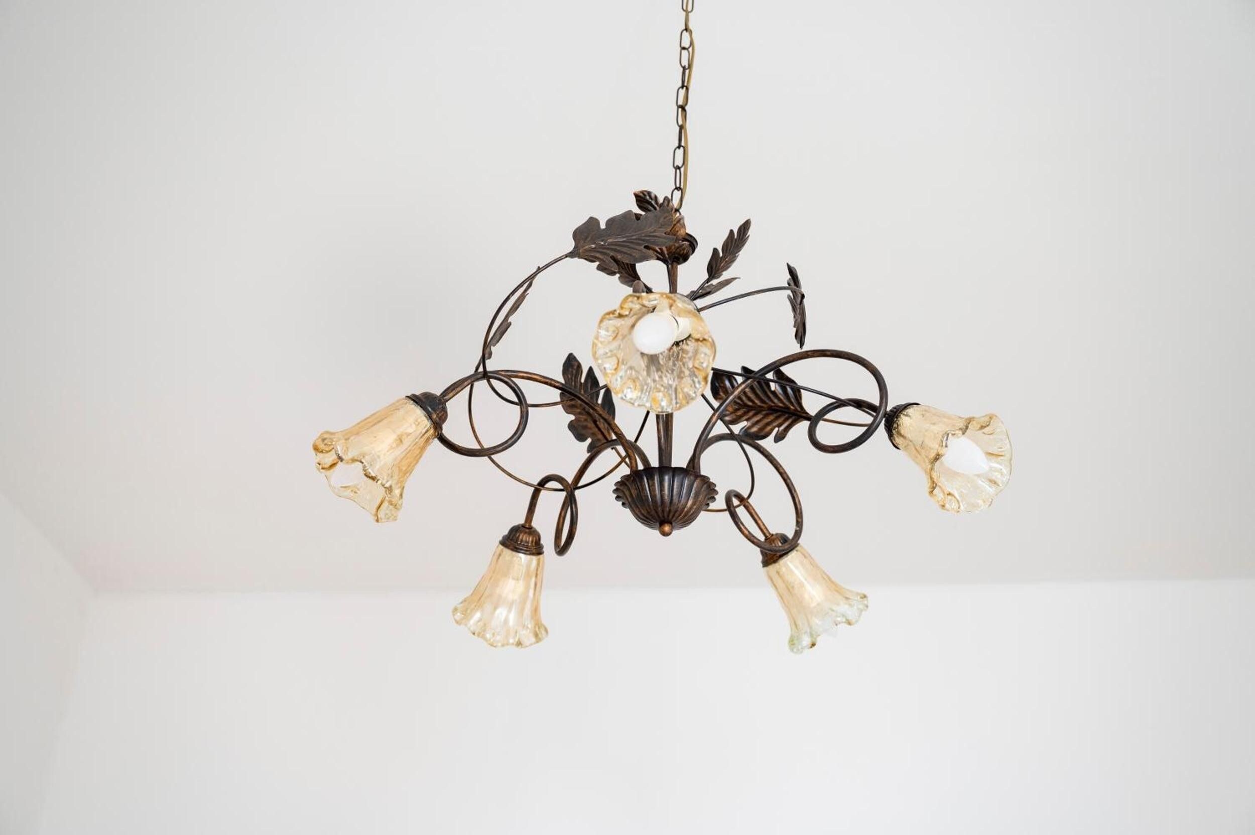 A chandelier with a leaf motif and multiple light fixtures.