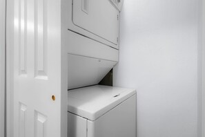 A white laundry room with a washing machine and a dryer. - Après Tahoe - 4BR Mountain Home (Stateline)