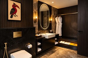 A modern bathroom with a large mirror, a sink, a toilet, and a shower area. - Polo Hotel, Kohima (Kohima)