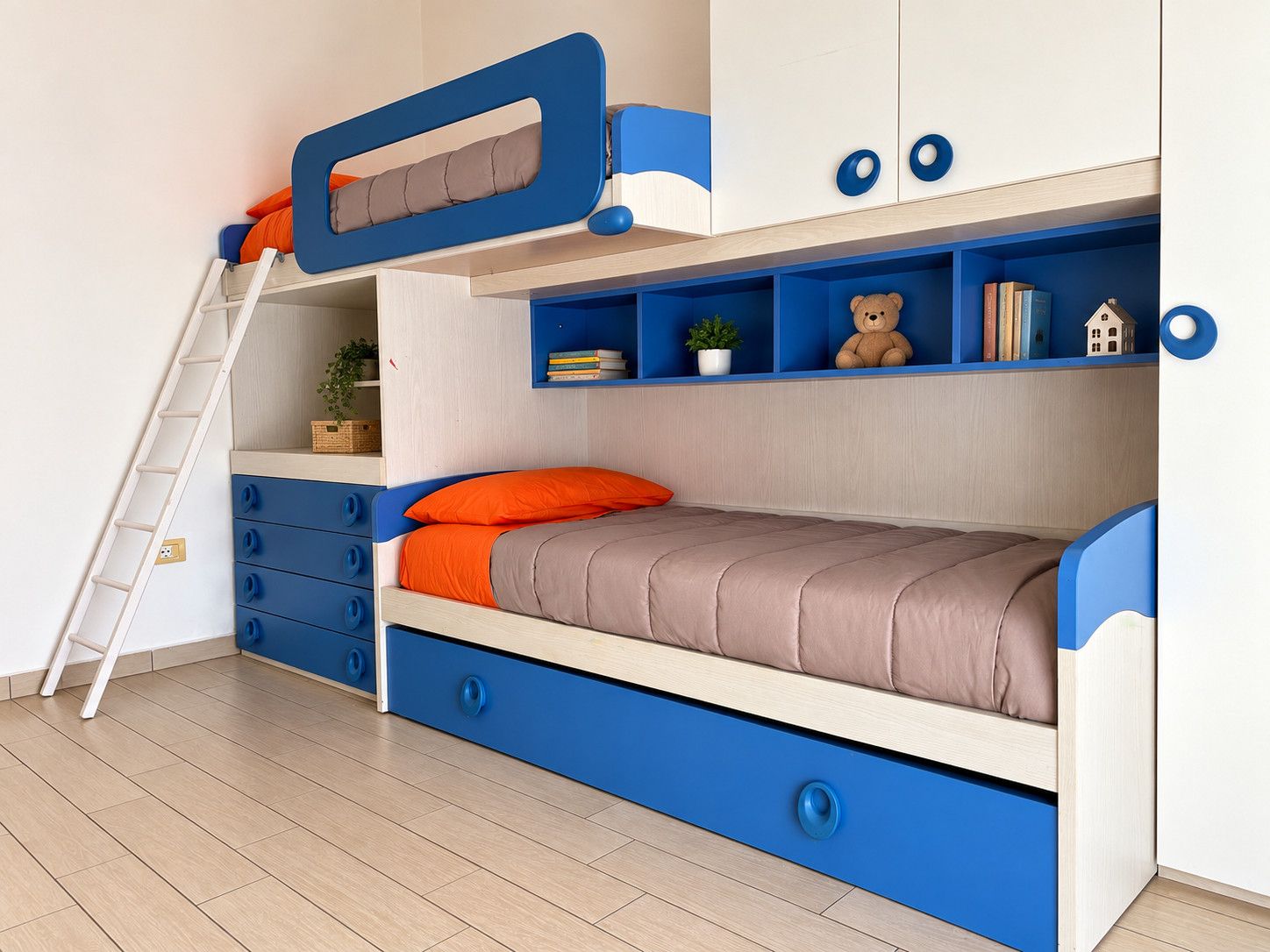 A bunk bed with a desk and shelving, a ladder, and a small plant.