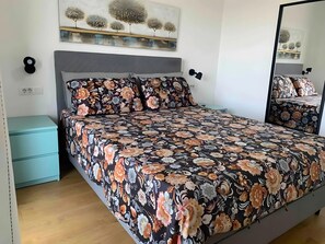 A bedroom with a bed, a nightstand, a wall-mounted shelf, and a mirror. - Holiday Home 'Aurora' with Private Pool, Wi-Fi and Air Conditioning (Marčana)